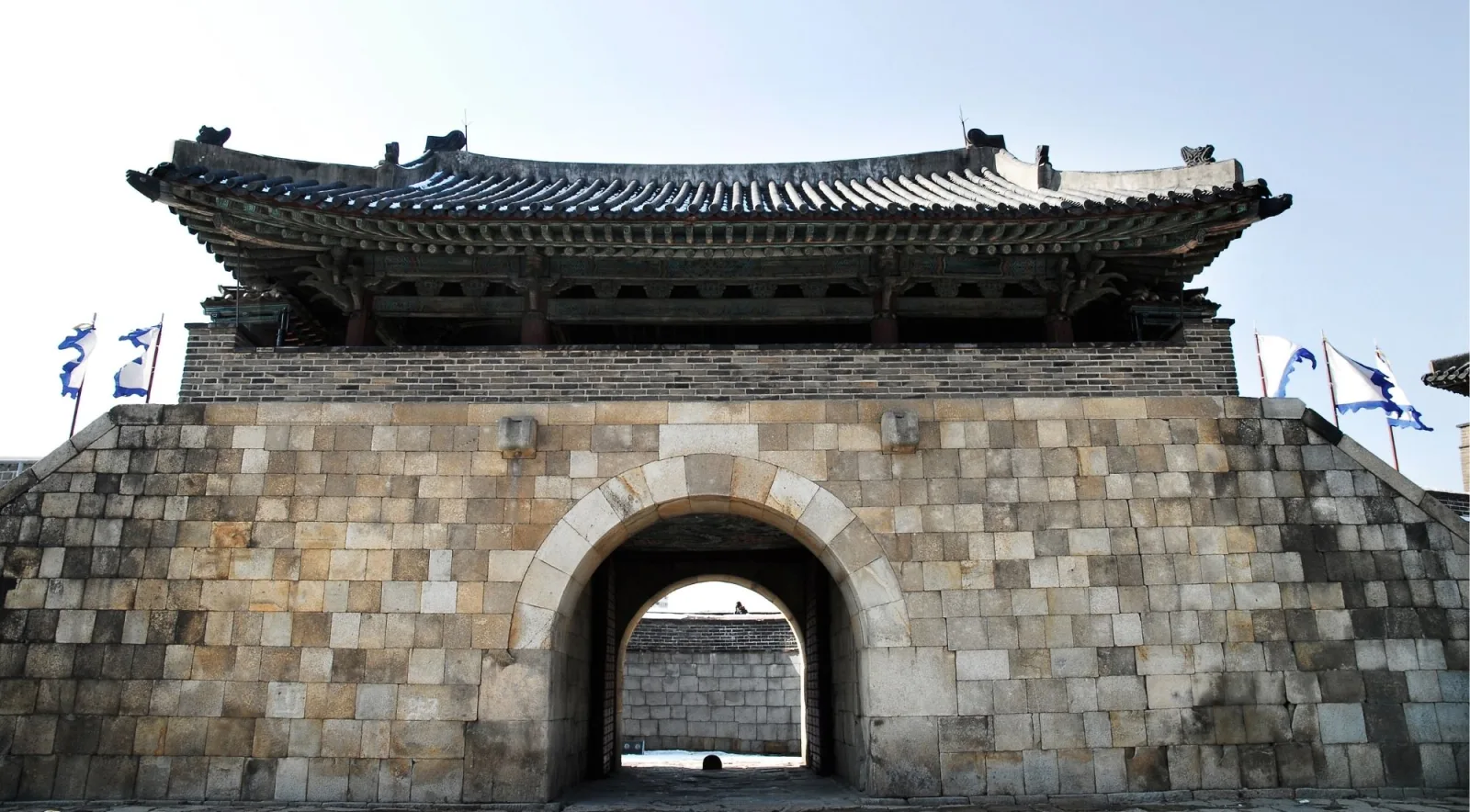 Front elevation of a stone fortress gate at Hwaseong with its tiled pavilion roof