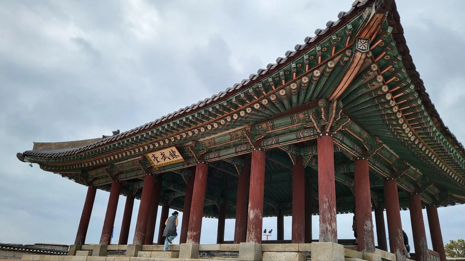 Painted eaves and columns of a pavilion on the Hwaseong Fortress wall