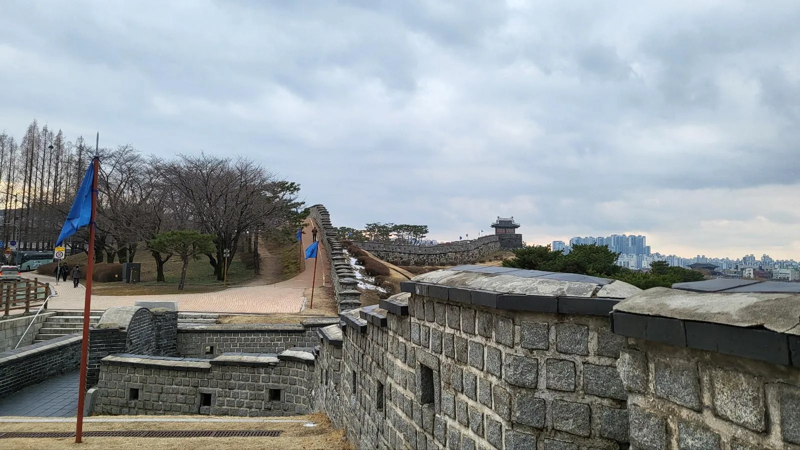 Hwaseong Fortress wall and flag on a winter afternoon