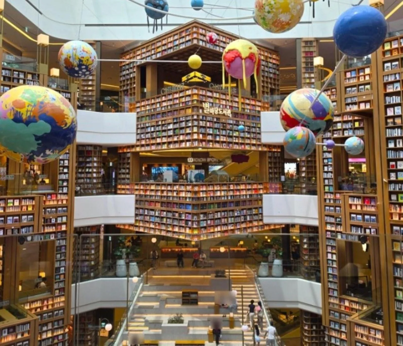 Balloons suspended among the bookshelves of the Starfield Suwon library atrium