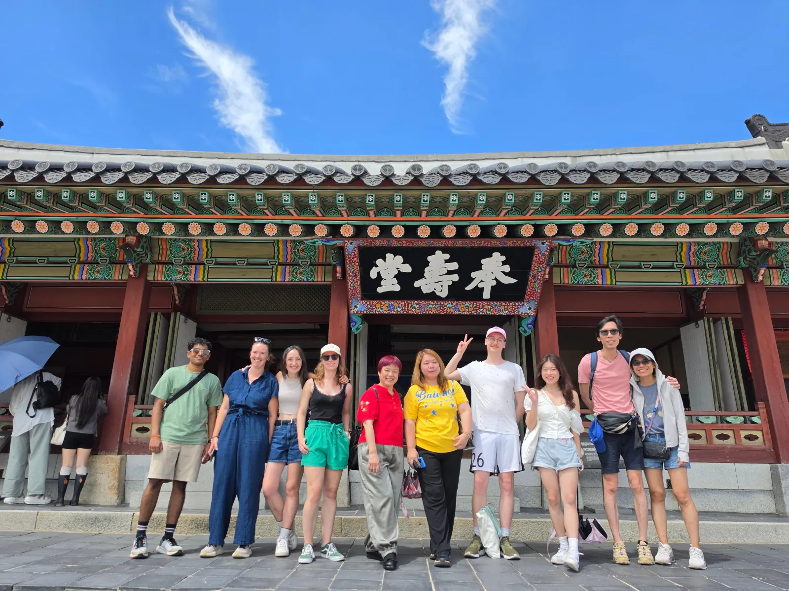 Tour group posing at the main gate of Hwaseong Haenggung Palace